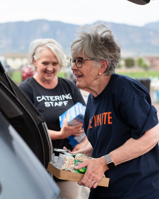 volunteer catering staff loading food into vehicles